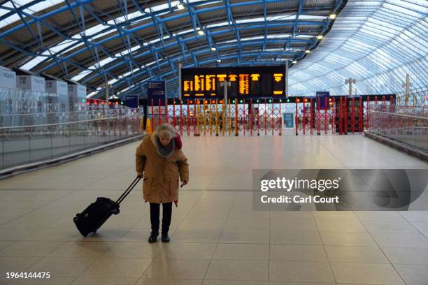 An elderly woman walks away from a closed platform as she tries to find a train to Richmond during a strike by members of the Associated Society of...