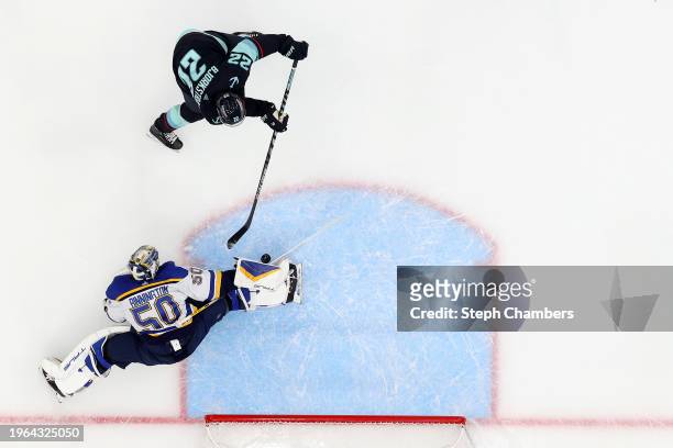 Jordan Binnington of the St. Louis Blues makes a stick save against Oliver Bjorkstrand of the Seattle Kraken during the third period at Climate...