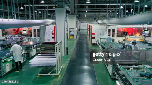 Employees work on the production line of solar panels at a workshop of Jiangsu Dongci New Energy Technology Co., Ltd. On January 26, 2024 in Suqian,...