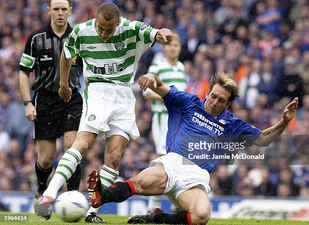 Henrik Larsson of Celtic is tackled by Fernando Ricksen of Rangers during the Bank of Scotland Scottish Premier League match between Glasgow Rangers...