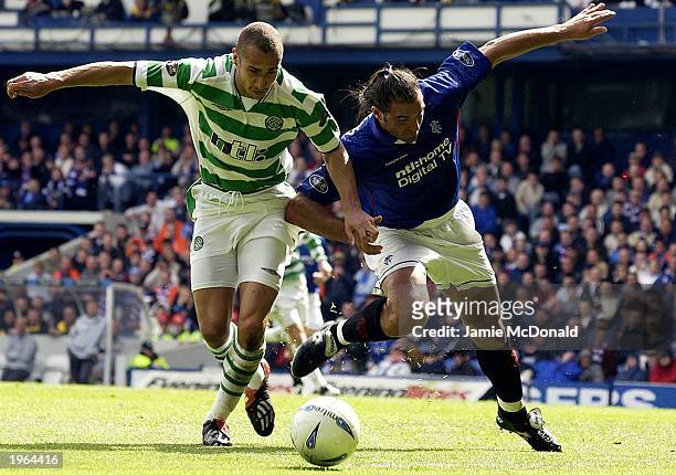 Henrik Larsson of Celtic is tackled by Lorenzo Amoruso of Rangers during the Bank of Scotland Scottish Premier League match between Glasgow Rangers...
