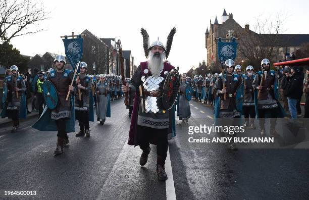 Guizer Jarl Richard Moar walks with members of the Up Helly Aa 'Jarl Squad', as they parade through the streets of in Lerwick, Shetland Islands on...