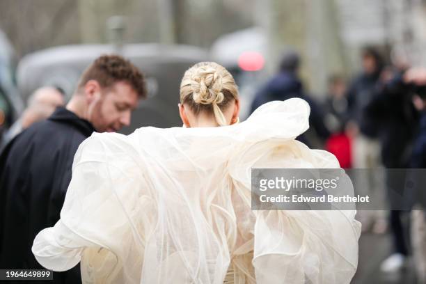 Leonie Hanne wears a white oversized tulle dress, outside Ashi Studio, during the Haute Couture Spring/Summer 2024 as part of Paris Fashion Week on...