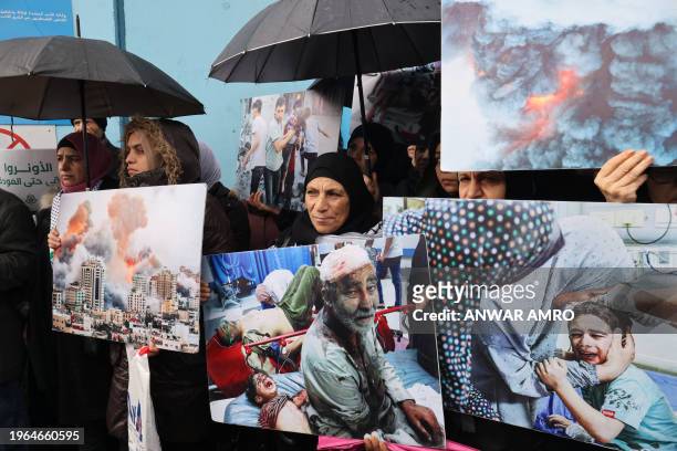 Palestinian refugees gather outside the offices of the UN agency for Palestinian refugees, UNRWA, in Beirut on January 30, 2024 to protest against...