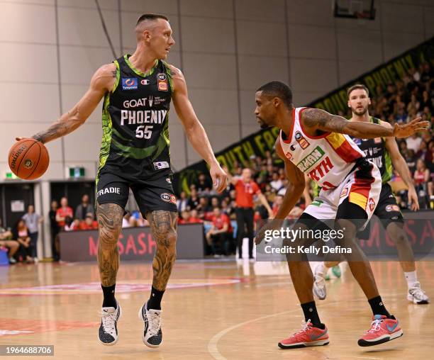 Mitchell Creek of the Phoenix handles the ball against Bryce Cotton of the Wildcats during the round 17 NBL match between South East Melbourne...