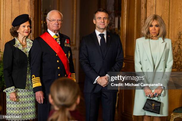 Queen Silvia and King Carl XVI Gustaf of Sweden pose for a picture with France's president Emmanuel Macron and wife Brigitte Macron after giving a...