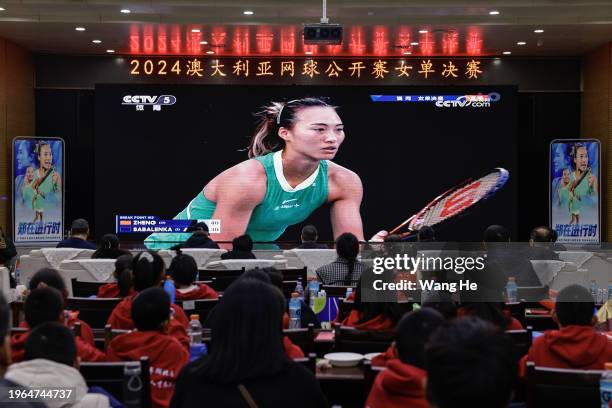 People watch a live broadcast of the Australian Open women's singles final match between Qinwen Zheng of China and Aryna Sabalenka during the 2024...