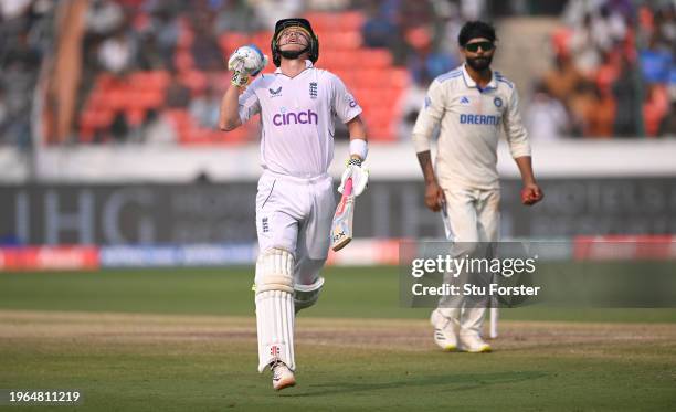 England batsman Ollie Pope celebrates his century as Ravindra Jadeja looks on during day three of the 1st Test Match between India and England at...