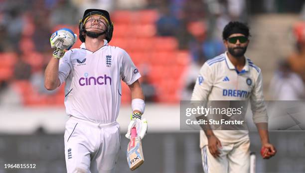 England batsman Ollie Pope celebrates his century as Ravindra Jadeja looks on during day three of the 1st Test Match between India and England at...