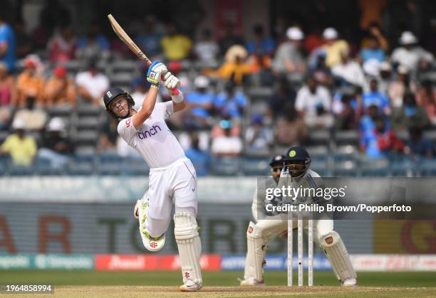 Ollie Pope of England hits out watched by Srikar Bharat during day three of the 1st Test Match between India and England at Rajiv Gandhi...