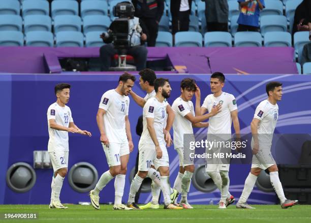 Abbosbek Fayzullaev of Uzbekistan celebrates his team-mates after scoring his sides second goal during the AFC Asian Cup Round of 16 match between...