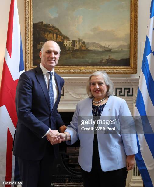 Britain's Minister for Europe Leo Docherty greets Greece's Deputy Minister Alexandra Papadopoulou at Carlton Gardens on January 30, 2024 in London,...