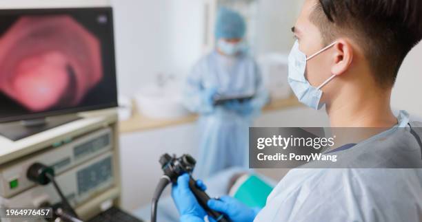 doctor do colonoscopy tumor surgery - gastroenterologie stock-fotos und bilder