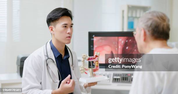 doctor explain tumor surgery - colon cancer stock pictures, royalty-free photos & images