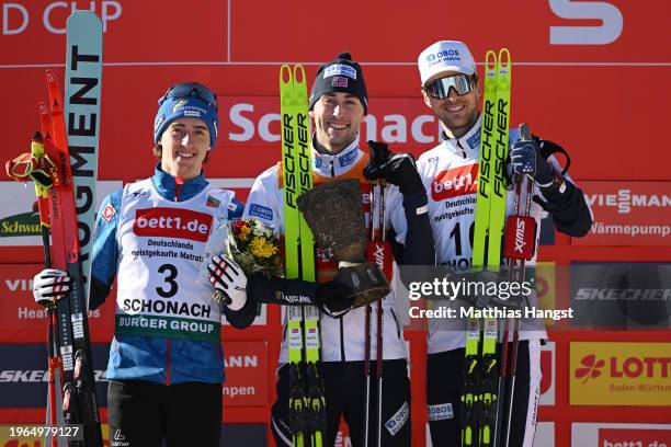 Second Place Stefan Rettenegger of Austria, First Place Jarl Magnus Riiber of Norway with their trophy, and Third Place Joergen Graabak of Norway,...