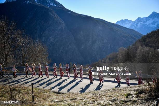 General view of people dressed in colorful clothes and wearing scary wooden masks decorated with mirrors during the Napoleon-themed Coumba Freida...