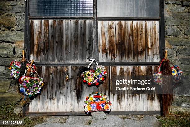 Scary wooden masks decorated with mirrors placed near a wooden door during the Napoleon-themed Coumba Freida Carnival on January 27, 2024 in Doues...