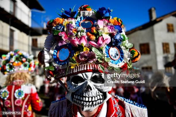 Man dressed in colorful clothes and wearing scary wooden masks decorated with mirrors during the Napoleon-themed Coumba Freida Carnival on January...