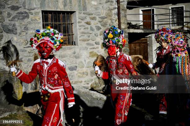 People dressed in colorful clothes and wearing scary wooden masks decorated with mirrors during the Napoleon-themed Coumba Freida Carnival on January...