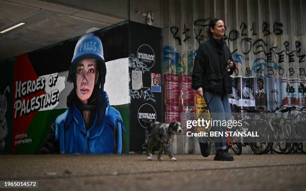 Photograph taken on January 30, 2024 in east London shows a graffiti made by street artist Ed Hicks, also known as @ed_hicks, depicting Palestinian...