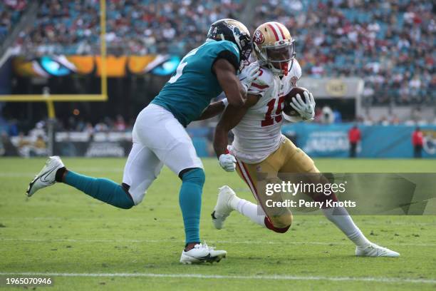 Jauan Jennings of the San Francisco 49ers runs upfield and tackled by Rudy Ford of the Jacksonville Jaguars during an NFL football game at TIAA Bank...