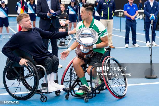 Dylan Alcott presents the championship trophy to Tokito Oda of Japan after winning their Men's Wheelchair Singes Final match against Alfie Hewett of...