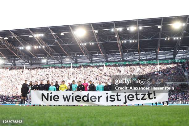 General view as the players of Bayern Munich hold a banner which reads "Nie Wieder Ist Jetzt", which translates to "Never Again Is Now", prior to the...