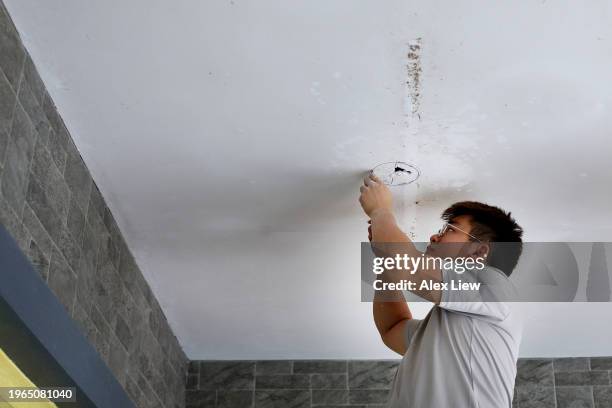 handyman - installing ceiling light fixture stock pictures, royalty-free photos & images