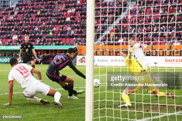 Aleksandar Pavlovic of Bayern Munich scores his team's first goal during the Bundesliga match between FC Augsburg and FC Bayern München at WWK-Arena...