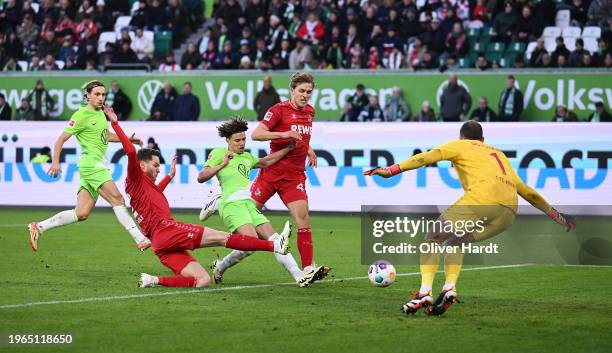 Kevin Paredes of VfL Wolfsburg scores their sides first goal past Marvin Schwabe of 1.FC Köln during the Bundesliga match between VfL Wolfsburg and...