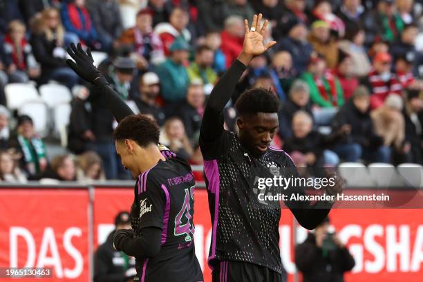 Alphonso Davies of Bayern Munich celebrates with Jamal Musiala of Bayern Munich after scoring his team's second goal during the Bundesliga match...