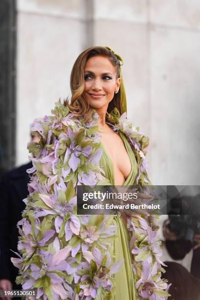 Jennifer Lopez wears a green gathered low neck dress with floral embroidery and details, outside Elie Saab, during the Haute Couture Spring/Summer...