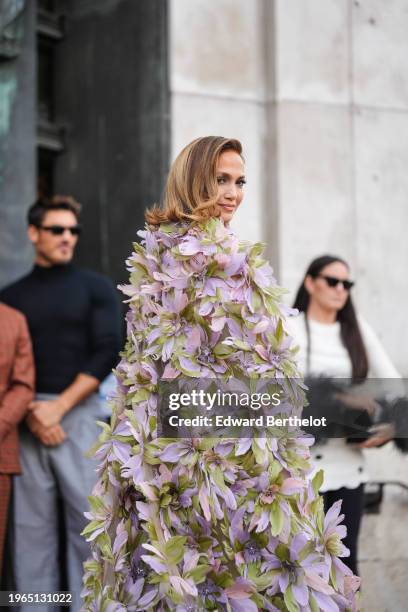 Jennifer Lopez wears a green gathered low neck dress with floral embroidery and details, outside Elie Saab, during the Haute Couture Spring/Summer...