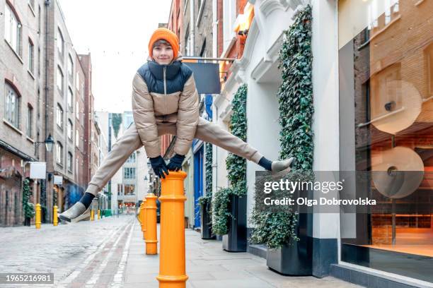 a teenage boy jumping over a street bollard - stakes day stock pictures, royalty-free photos & images