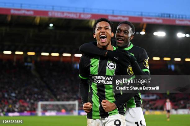 Joao Pedro of Brighton & Hove Albion celebrates with team mate Danny Welbeck after scoring the team's fourth goal and his hat trick during the...