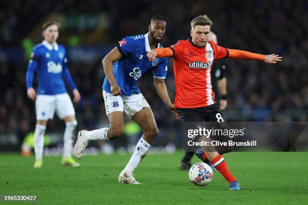 Luke Berry of Luton Town runs with the ball whilst under pressure from Beto of Everton during the Emirates FA Cup Fourth Round match between...