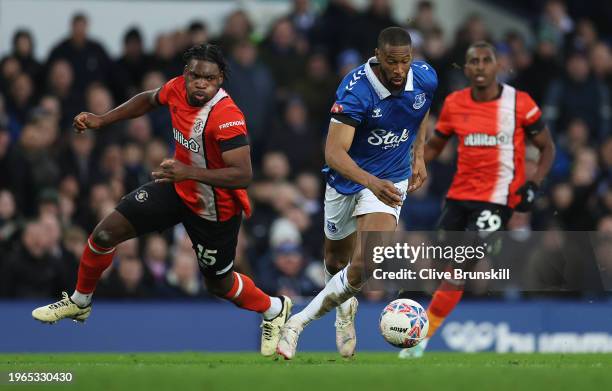 Beto of Everton runs with the ball whilst under pressure from Teden Mengi of Luton Town during the Emirates FA Cup Fourth Round match between...