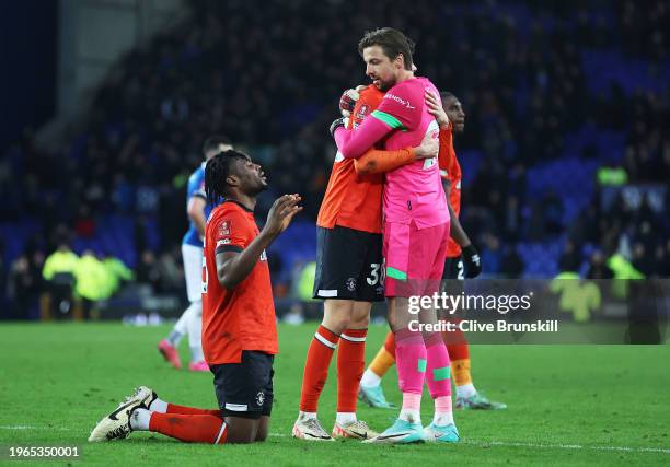 Joe Johnson and Tim Krul of Luton Town embrace as teammate Teden Mengi celebrates after the team's victory in the Emirates FA Cup Fourth Round match...