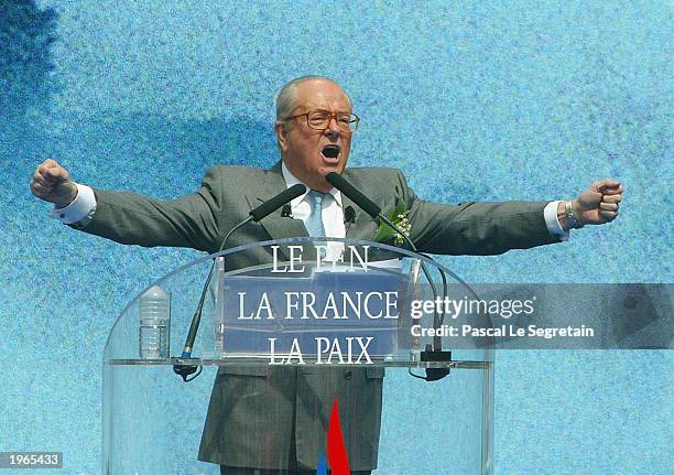 Extreme far-right National Front party leader Jean Marie Le Pen gestures during his speech May 1, 2003 in Paris, France. Le Pen spoke at the end of...