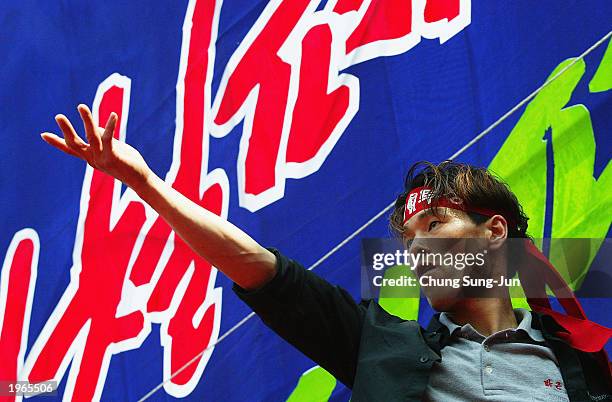 South Korean worker shouts slogans during a May Day protest in Seoul May 1, 2003. Tens of thousands South Korean union members gathered across the...