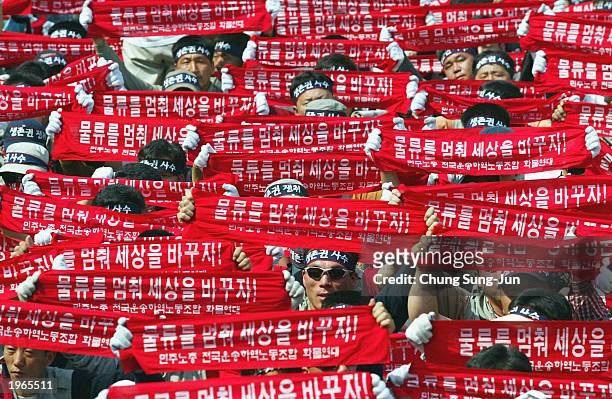 South Korean workers shout slogans as they show banners reading 'Let's change the world by stopping transportation!' during a May Day protest in...