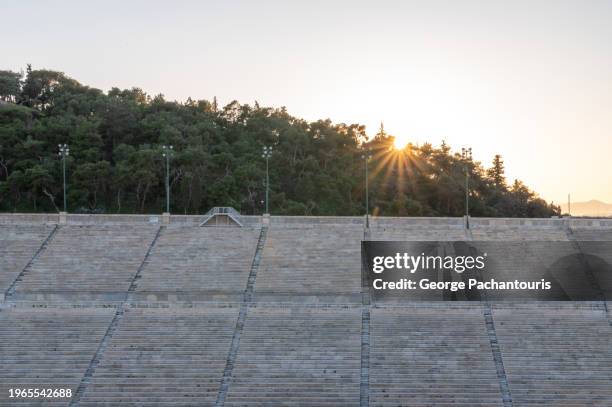 sunlight over the stadium seating area - antiche olimpiadi foto e immagini stock