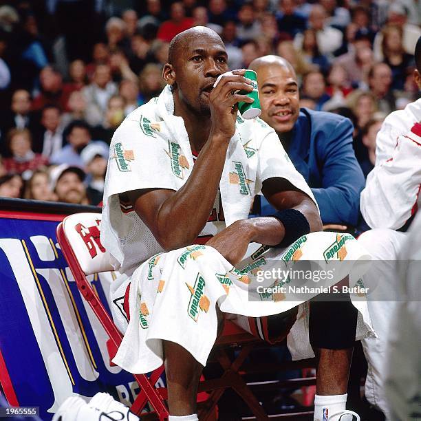 Michael Jordan of the Chicago Bulls takes a water break during the NBA game against the Miami Heat at the United Center on January 26, 1996 in...