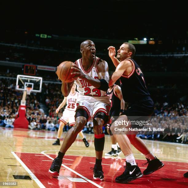 Michael Jordan of the Chicago Bulls looks to shoot the ball against the Miami Heat in Game one of the Eastern Conference Finals during the 1997 NBA...
