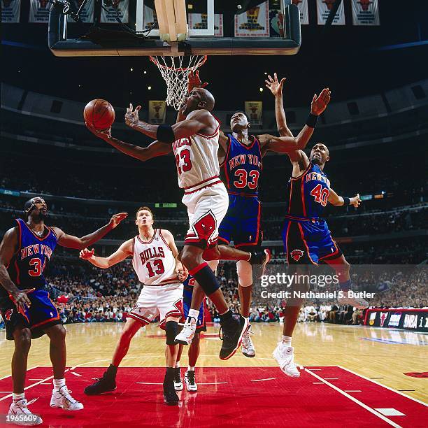 Michael Jordan of the Chicago Bulls takes a reverse layup against Patrick Ewing of the New York Knicks in Game five of the Eastern Conference...