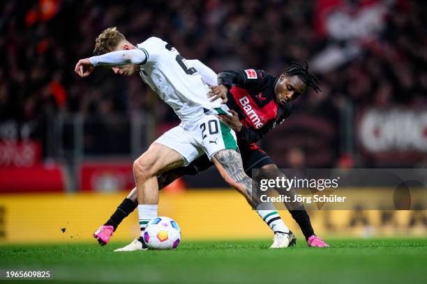 Jeremie Frimpong of Leverkusen is challenged by Luca Netz of Moenchengladbach during the Bundesliga match between Bayer 04 Leverkusen and Borussia...