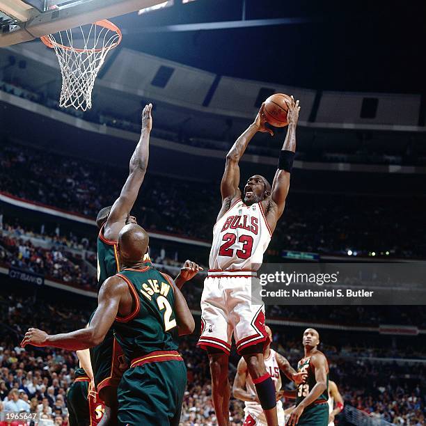 Michael Jordan of the Chicago Bulls grabs a rebound against the Seattle SuperSonics during Game two of the 1996 NBA Finals at the United Center on...