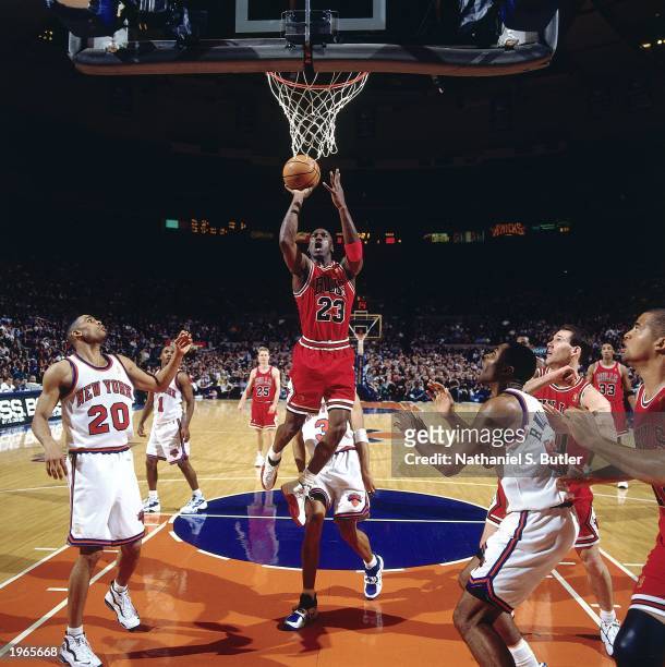 Michael Jordan of the Chicago Bulls takes a layup against the New York Knicks during the NBA game at Madison Square Garden on April 19, 1997 in New...