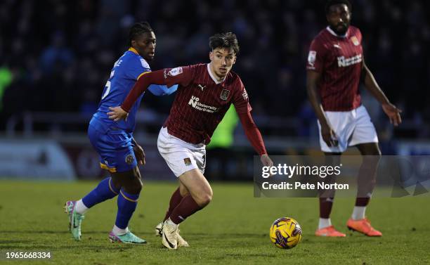 Kieron Bowie of Northampton Town moves forward with the ball away from Tunmise Sobowale of Shrewsbury Town during the Sky Bet League One match...