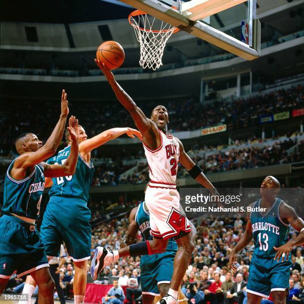 Michael Jordan of the Chicago Bulls drives to the hoop against the Charlotte Hornets during the NBA game at the United Center on November 3, 1995 in...